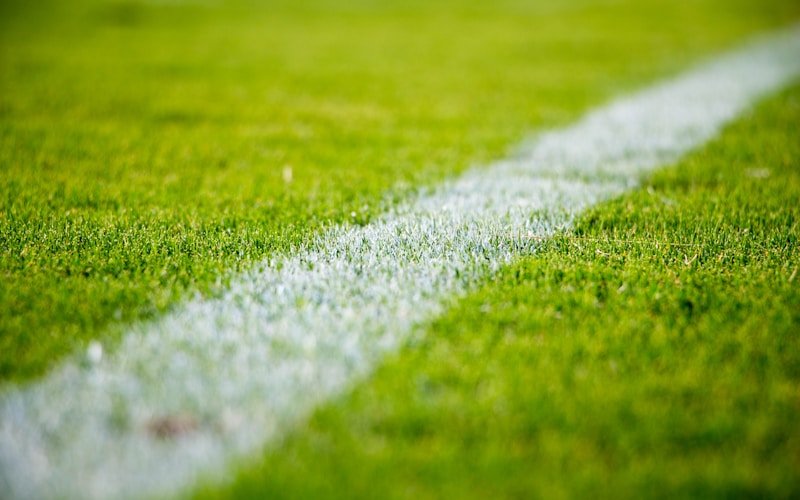 Football players from different national teams competing intensely on a green pitch during an international match