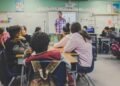 Students using AI tools in a modern classroom setting