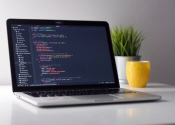 Developer coding with AI tools on laptop