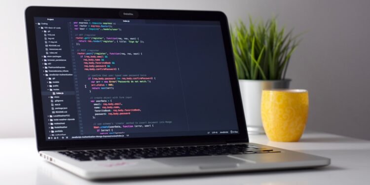Developer coding with AI tools on laptop