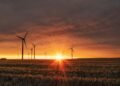 Wind turbines on a hillside at dusk