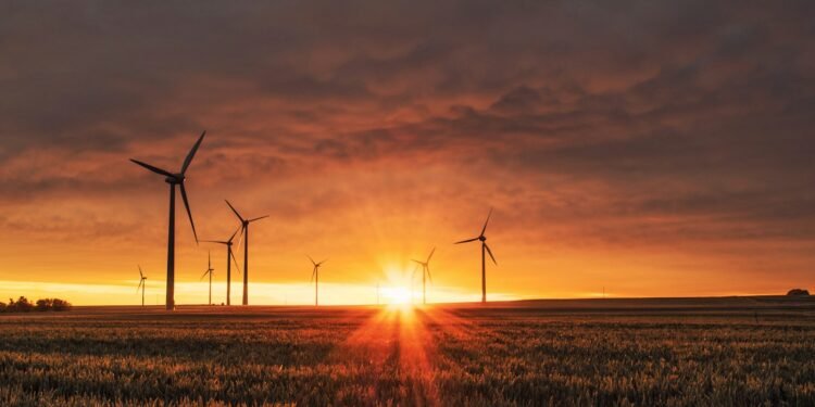 Wind turbines on a hillside at dusk