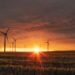 Wind turbines on a hillside at dusk