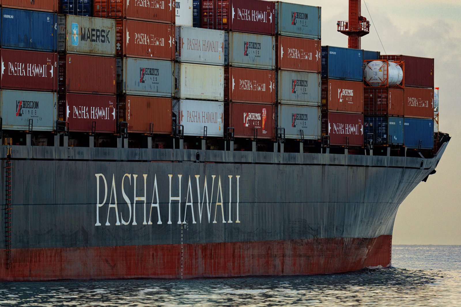 A cargo container ship at port with colorful shipping containers representing global maritime trade and supply chains