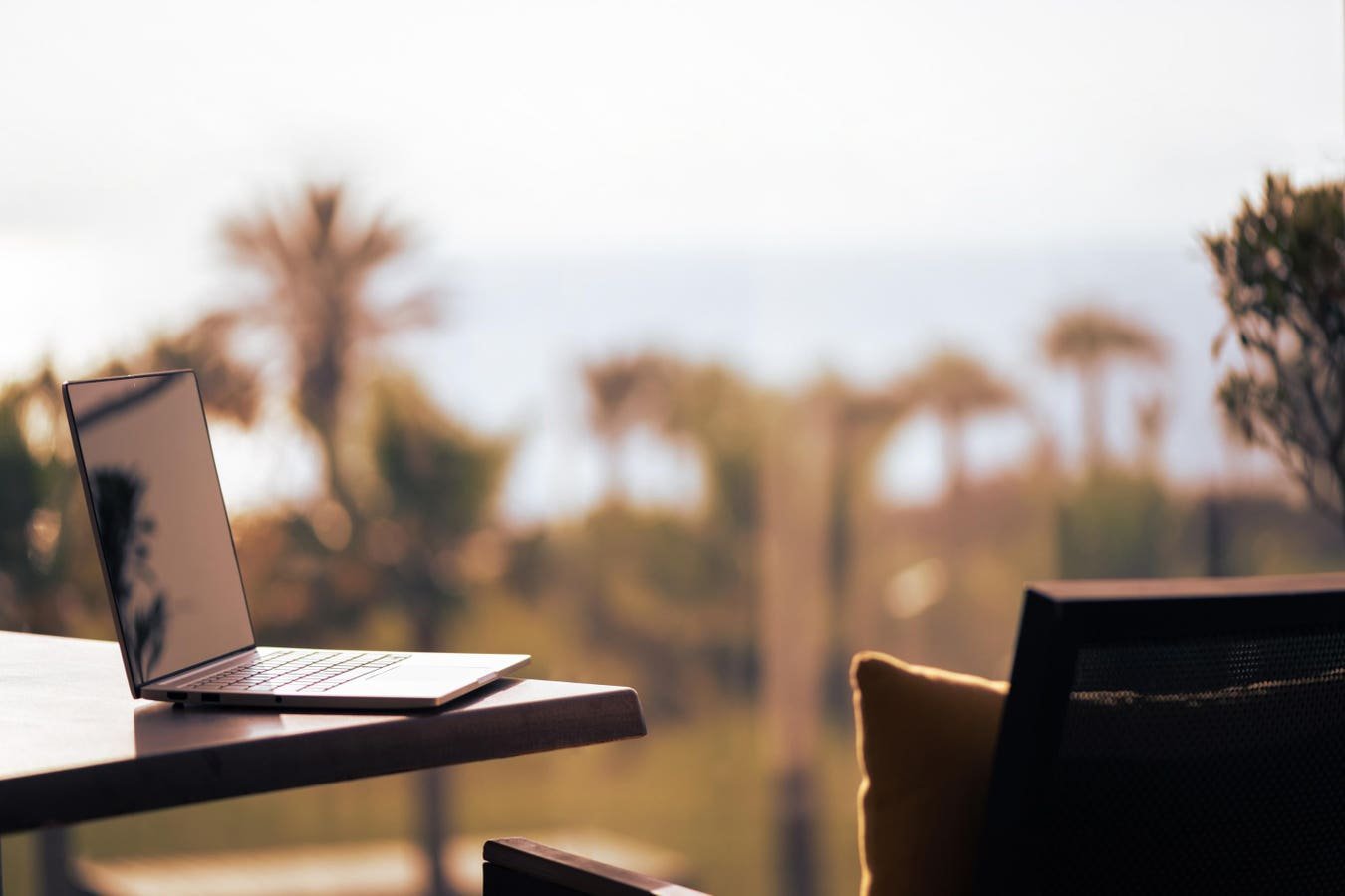 Digital nomad working remotely from a co-working space with laptop and smartphone