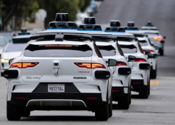 Robotaxi vehicle being blocked by emergency responders on a city street