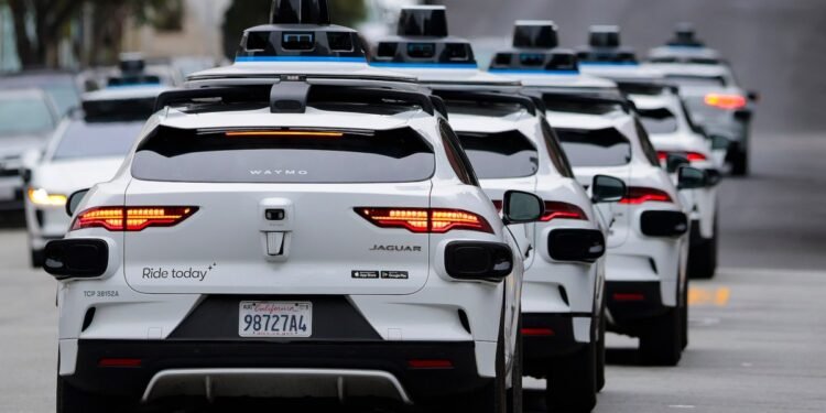 Robotaxi vehicle on street with first responder vehicles nearby