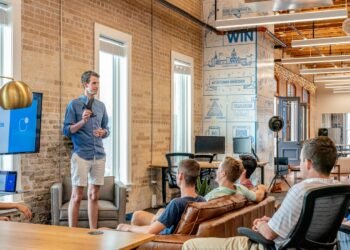 Team celebrating around a laptop in a startup office