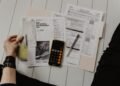 Financial documents, charts and a calculator on a desk