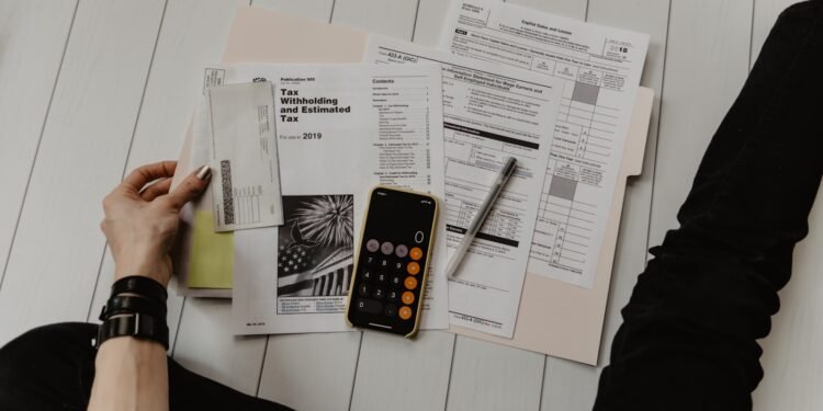 Financial documents, charts and a calculator on a desk