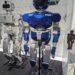 Humanoid service robot standing in a public technology exhibition space