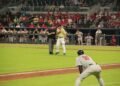 A baseball coach standing face to face with an umpire during a game