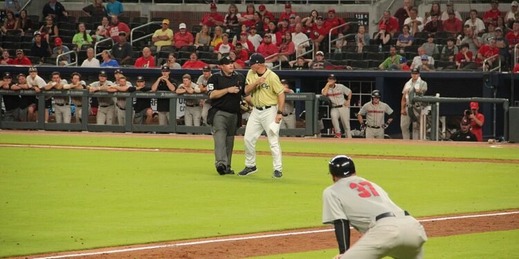 A baseball coach standing face to face with an umpire during a game