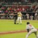 A baseball coach standing face to face with an umpire during a game