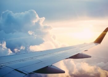 Aircraft wing above a layer of cloud at altitude