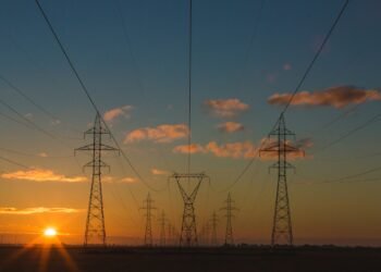 High-voltage power lines at sunset