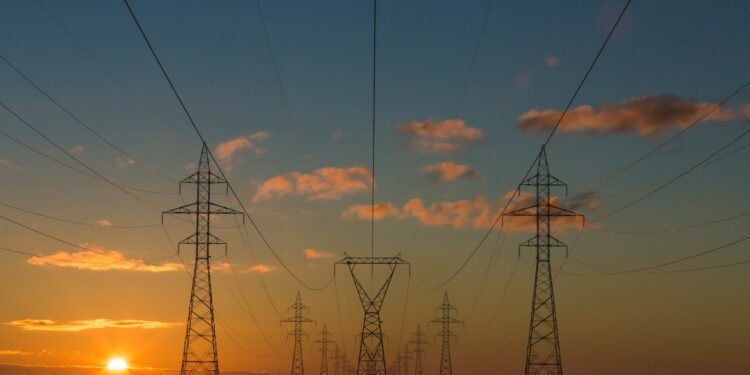High-voltage power lines at sunset