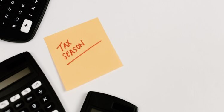 Calculators and a sticky note reading Tax Season