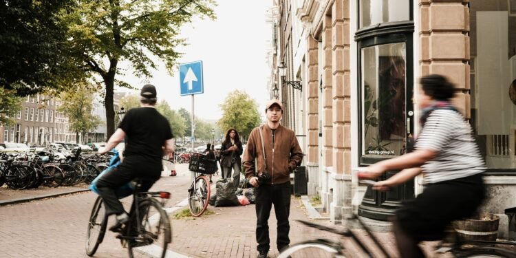 Cyclists riding along a busy street in Amsterdam