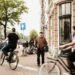 Cyclists riding along a busy street in Amsterdam