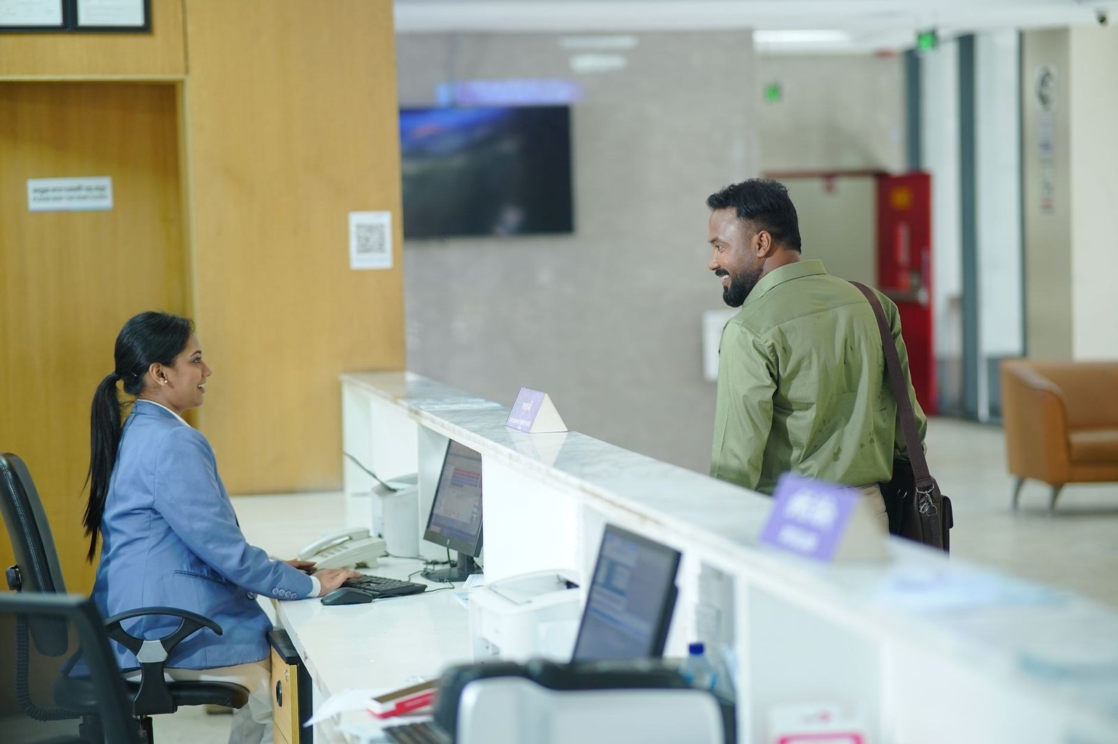 A service desk where a newcomer is helped with registration