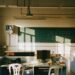 Sunlight streaming into an empty classroom with rows of desks